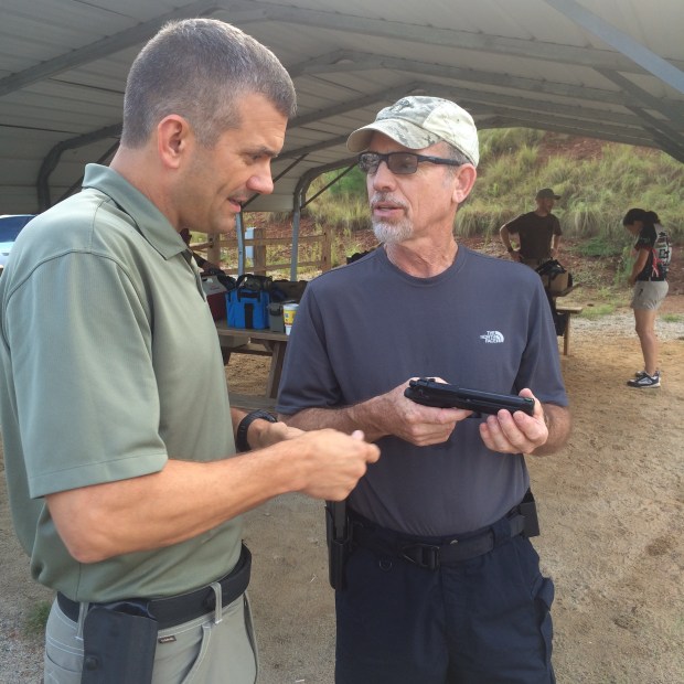 Sheriff Mark Moore and Ernest Langdon discussing Beretta 92 variants