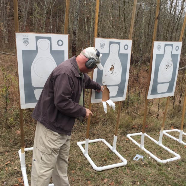 Tom Givens demonstrating what the gasses from the cylinder gap will do. He turned the target and held the revolver along side of it and fired a shot.